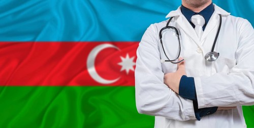 Male doctor with stethoscope on Azerbaijan flag. Doctor holding stethoscope on Azerbaijan flag