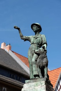 Symbolic statue of a young craftsman with a dog as a sign of civic freedom and loyalty in the World