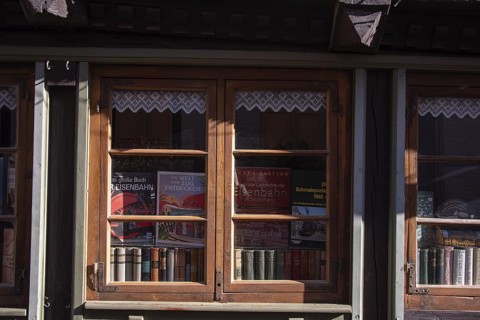 Decorated shop window with historical railway books and nostalgic flair, antiquarian bookshop,
