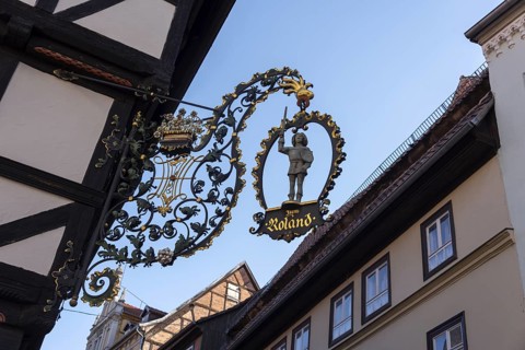 Traditional cantilever sign Zum Roland on a half-timbered house, Quedlinburg, Saxony-Anhalt,