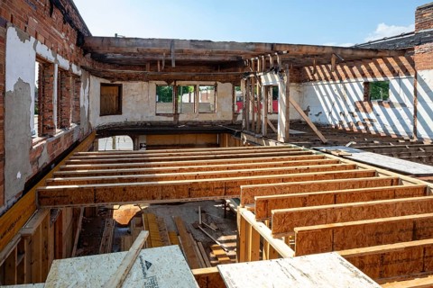 Detroit, Michigan - Workers rehab a long-vacant and crumbling commercial building in the