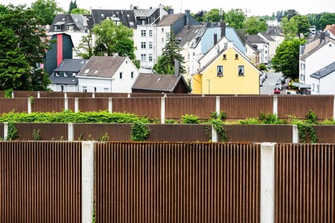 A row of noise barriers in front of a residential area at the Sonnborn junction in Wuppertal,