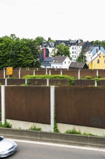 A row of noise barriers in front of a residential area at the Sonnborn junction in Wuppertal,