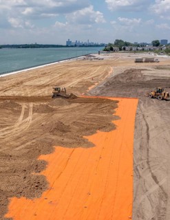 Detroit, Michigan - Workers spread clean dirt after old industrial contamination of cadmium,