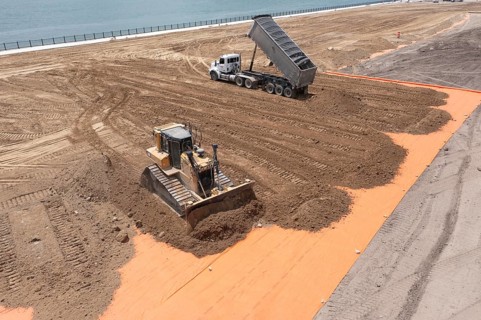 Detroit, Michigan - Workers spread clean dirt after old industrial contamination of cadmium,