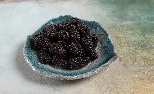 Fresh blackberry berry, on a plate, top view, no people