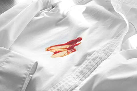 White shirt stained with ketchup, no people, close-up, selective focus