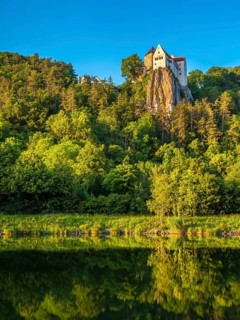 Prunn Castle on a steep cliff above the AltmÃ¼hl Valley in the evening light, reflection in the