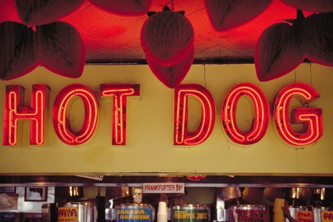 Illuminated advertising at a hot dog stand, New York City, USA