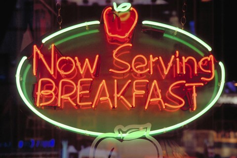 Morning illuminated advertising at a restaurant, New York City, USA
