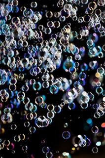 Many, small iridescent and floating soap bubbles against a black background, Recklinghausen, North