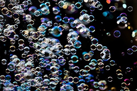 Many, small iridescent and floating soap bubbles against a black background, Recklinghausen, North