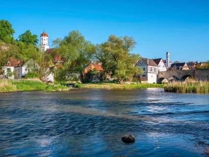 View over the river Wörnitz to the old town with the Stone Bridge and the churches of St Barbara