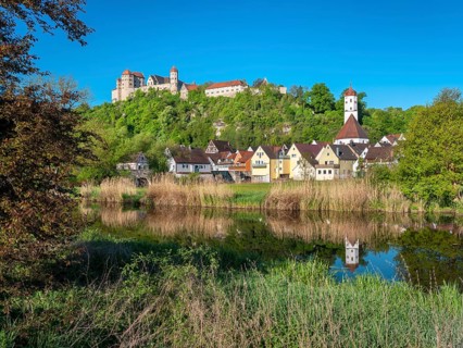 Castle and old town with St Barbara's Church reflected in the River Wörnitz, Harburg, Donau-Ries,