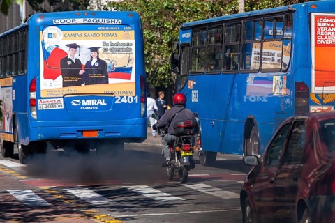 Buses in motion emitting pollution, City of Quito. Pichincha province, Ecuador, South America