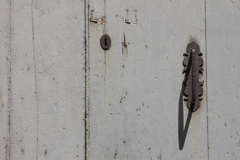 Metal fittings on an old wooden door, Tuscany, Italy