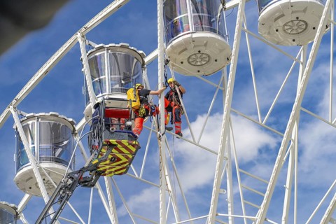 Workers in climbing gear carry out a rescue operation on the Ferris wheel, fire brigade exercise