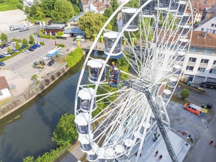 View from above of Ferris wheel and rescue operation in urban environment, fire brigade exercise