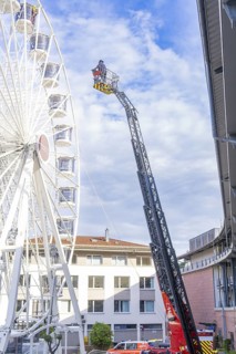 Fire brigade ladder next to a building front with operating platform in use, fire brigade exercise