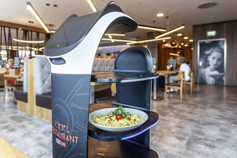 Furniture store XXXLutz Mann Mobilia Karlsruhe. In the restaurant, serving robot Lutzi supports the