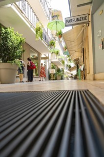 Frog's-eye view of a passageway with plants and umbrellas, Merano, South Tyrol, Italy