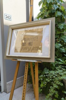 Artwork on easel next to a plant in front of a grey wall, Merano, South Tyrol, Italy