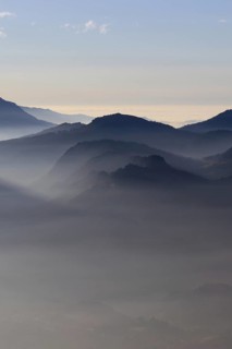 Mountain silhouettes... Alpine peaks and mountain ranges in the Bavarian Alps, light fog rises from