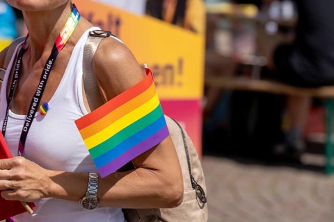 Participant with rainbow flag at Christopher Street Day in Leipzig on 28 June 2025