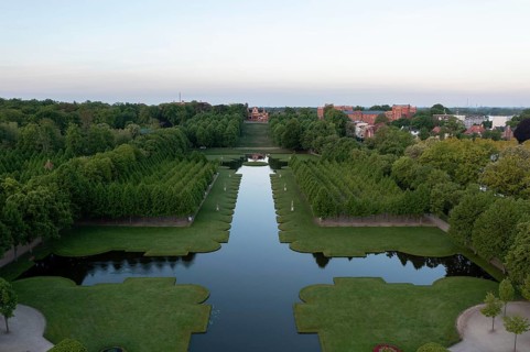 Symmetrically laid out avenues and a central water basin characterise the baroque palace garden in