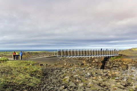 Metal lattice bridge over continental divide, Mid-Atlantic Ridge, volcanic landscape, Reykjanes
