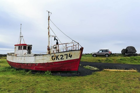 Shipwreck, fishing boat in a meadow, Gardur campsite near KeflavÃ­k, SuÃ°urnes, Sudurnes, Reykjanes