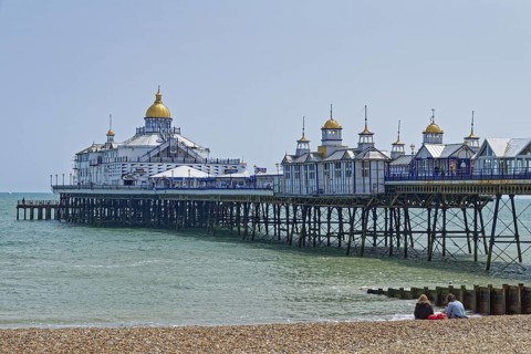 Beach and pier in Eastbourne, seaside resort on the English Channel, in the county of East Sussex,