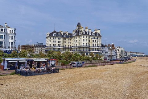 Beach and building on the seafront in Eastbourne, seaside resort on the English Channel, in the