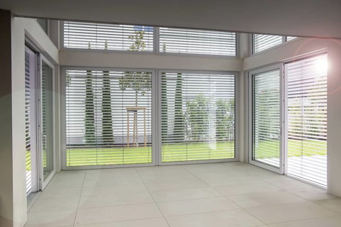 Large sliding windows with external blinds on a new building