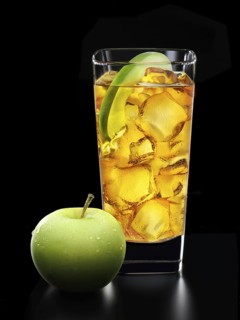 Cocktail in a long drink glass on ice with half an apple slice and apple as garnish in front of a