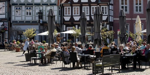 People in the outdoor catering area in the old town with many half-timbered houses, GroÃŸer Plan,
