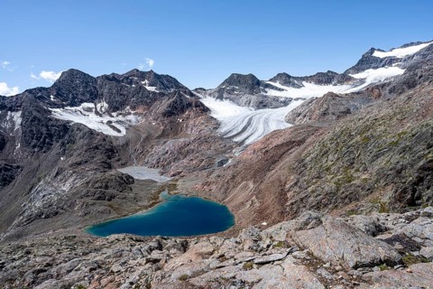 Blue glacial lake in a rocky mountain landscape, behind Königshofspitz and Ãœbeltalferner glacier,