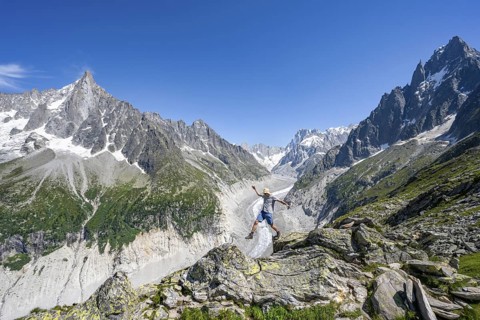 Picturesque mountain landscape with imposing mountain peaks and glaciers, mountaineer on hiking
