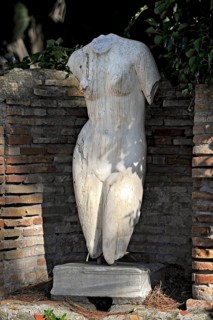 Naked woman, torso of a female statue, marble carving, remains, ruins, ancient port city of Rome,
