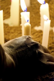 Hand placing a candle as an offering during prayers at a religious festival