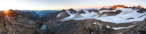 Panorama at sunrise with sun star, high mountain landscape, view of blue glacial lakes, mountain