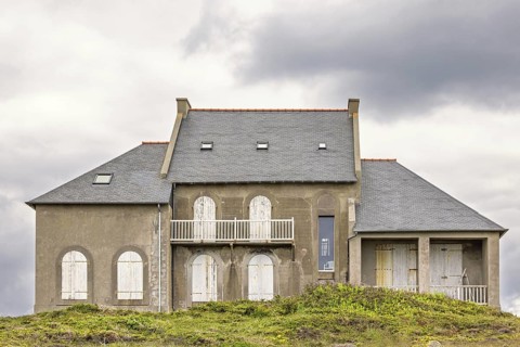 Old house with closed window shutters on a hill at a coastal area, Camaret-sur-Mer, Crozon