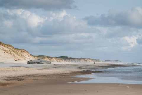 Wide beach with sand dunes and cloudy sky along the coast, near Hvide Sande, North Sea, Denmark