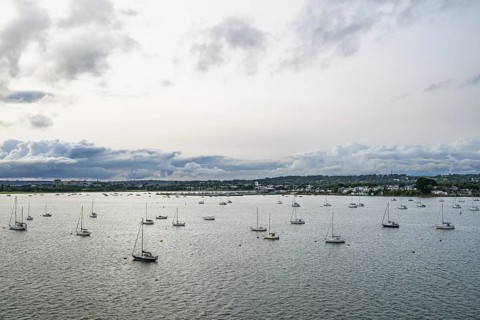 Yachts over Ramshorn Lake and Poole, Brownsea, Dorset, England, United Kingdom
