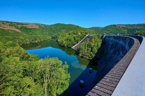 View of a large dam with river and surrounding forest landscape, summer, Urft dam wall, Obersee,