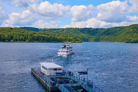 A departing passenger ship, on a large lake under a cloudy sky, summer, Rursee, Rurtalsperre,
