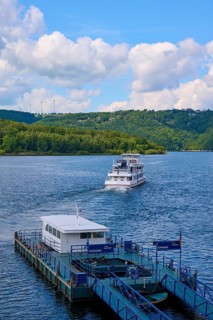 A passenger ship moves away from the landing stage, on a large lake, summer, Rursee, Rurtalsperre,