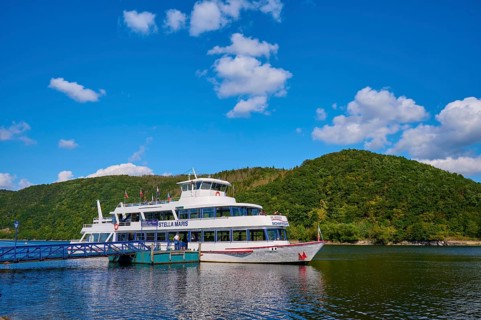 Passenger ship at the jetty, surrounded by green hills and blue sky, summer, Rursee, Rurberg,