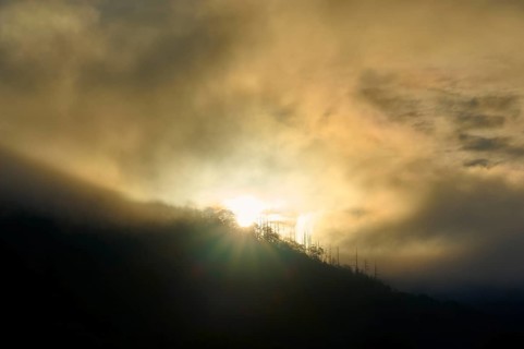 Sunrise breaks through fog over a mountain, dramatic play of light, summer, Rursee, Obersee,