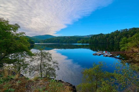 Clear water reflection of a wooded mountain on the lake, summer, Rursee, Obersee, Simmerath, Eifel